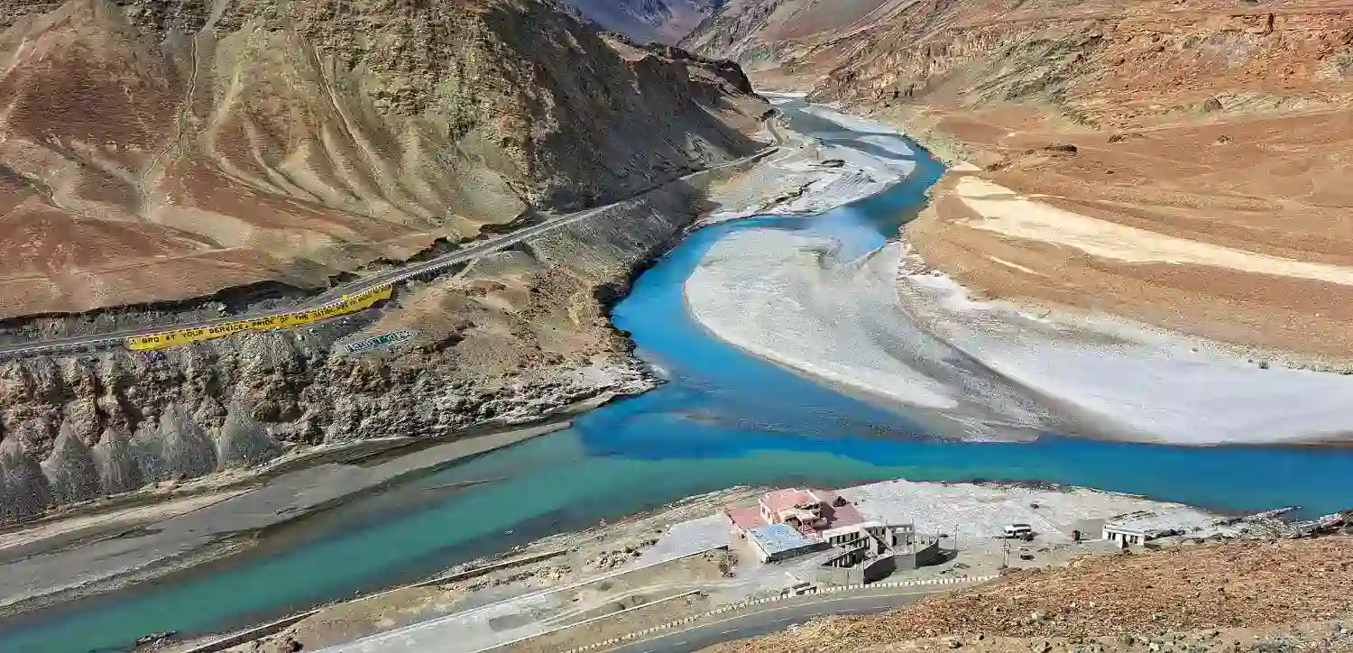 Aerial view of the Sangam Confluence where the Indus and Zanskar rivers meet, one of the top places to visit in Ladakh near Nimmu House.